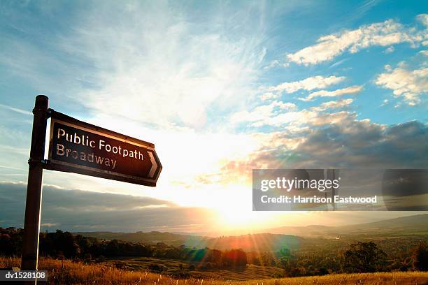 public footpath sign for the broadway, cotswolds, at sunset - footpath sign stock pictures, royalty-free photos & images