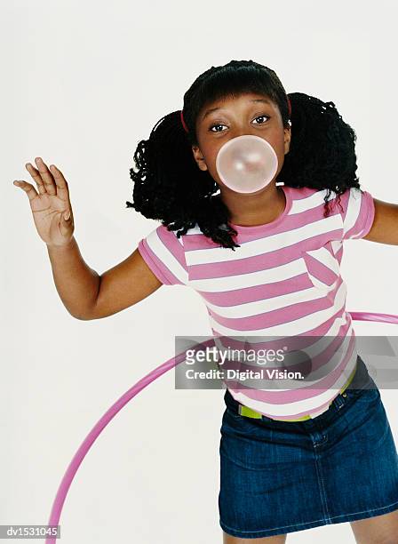 girl in a striped t-shirt plays with a hoop and blows gum - wonky fringe stock pictures, royalty-free photos & images