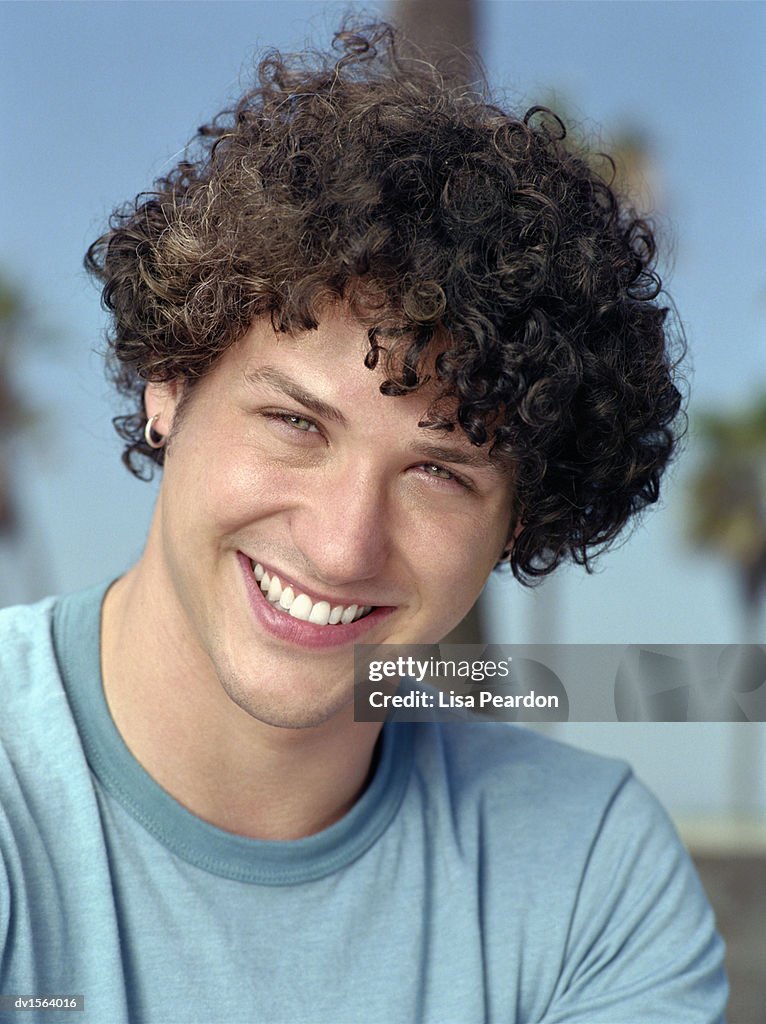 Portrait Of A Smiling Teenage Boy With Curly Hair High-Res Stock Photo -  Getty Images