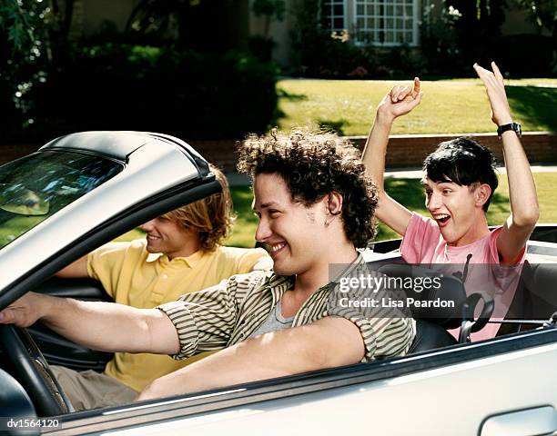 three teenagers sit driving in a convertible car - fahrspaß stock-fotos und bilder