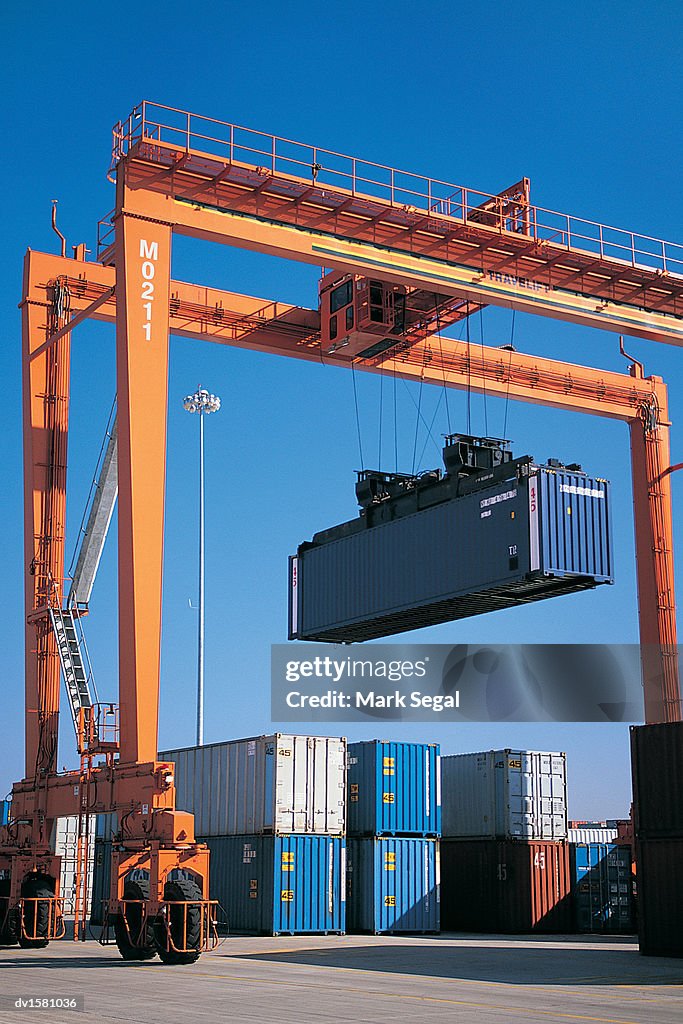 Crane Lifting a Cargo Container in a Shipping Yard, Joliet, Illinois, USA