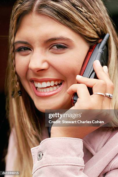 woman with braided hair using a mobile phone - stewart stock-fotos und bilder