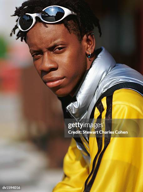 young man with dreadlocks and wearing sunglasses and a yellow jacket - stewart stock pictures, royalty-free photos & images