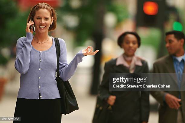 woman using a mobile phone on the street - stewart stock pictures, royalty-free photos & images