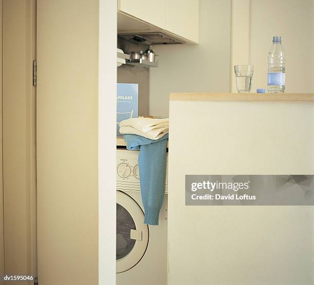 washing machine, washing powder and water bottle in a utility room - powder room stock pictures, royalty-free photos & images