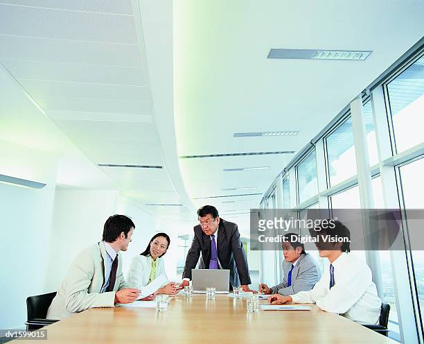 group of businesspeople planning strategy all looking at one man - all stock pictures, royalty-free photos & images
