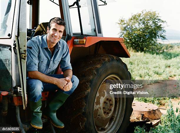 farmer sitting on a tractor in a field - tractor 個照片及圖片檔