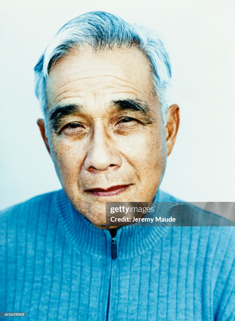 Studio Portrait of an Elderly Man in a Blue Jumper