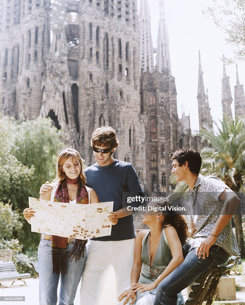 Two Young Couples Read a Map in Front of the Sagrada Familia, Barcelona