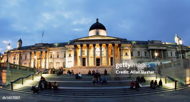 large group of people sitting on the steps in front of the national gallery, london, england, united kingdom - vigils are held for the victims of the london bridge terror attacks stockfoto's en -beelden