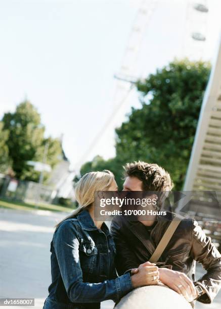 couple kissing near the millenium wheel, london - vigils are held for the victims of the london bridge terror attacks stockfoto's en -beelden