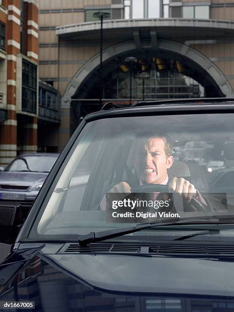 annoyed man driving a car - road rage stock pictures, royalty-free photos & images