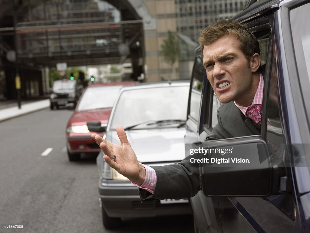 Annoyed Driver Looking out the Window Gesturing