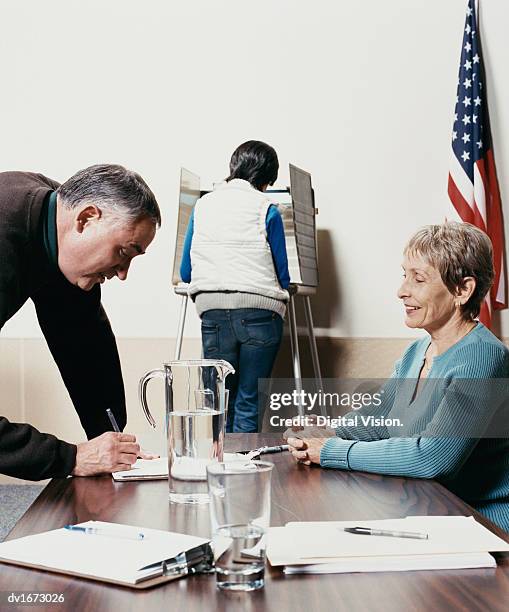 people voting at a polling station - republican presidential nominee donald trump holds rally in new hampshire on eve of election stockfoto's en -beelden