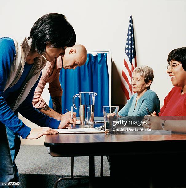 voters at a polling station - republican presidential nominee donald trump holds rally in new hampshire on eve of election stockfoto's en -beelden