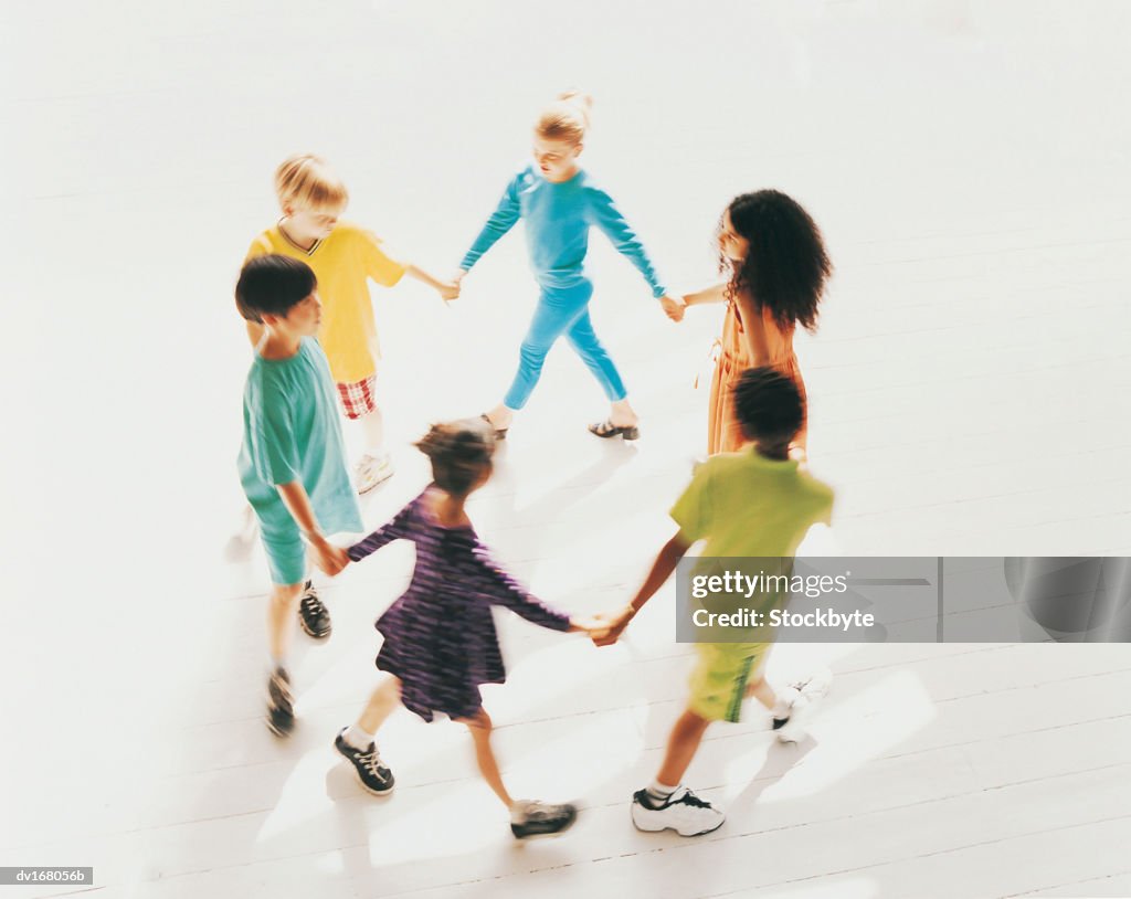 Children joining hands, walking in circle