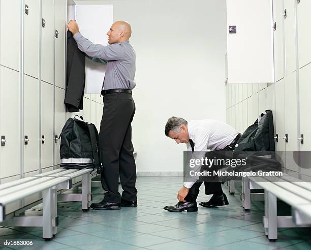 two men getting ready in a changing room - lace fastener stock pictures, royalty-free photos & images