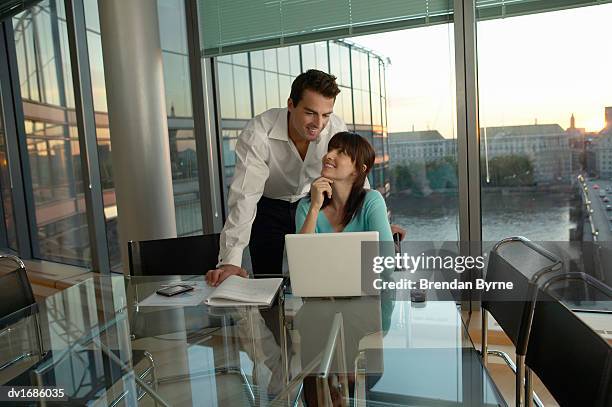 thirty something business couple working in a penthouse apartment - brendan stock-fotos und bilder