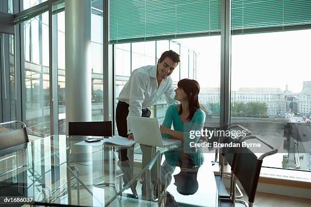 thirty something business couple working in a penthouse apartment - brendan stock-fotos und bilder