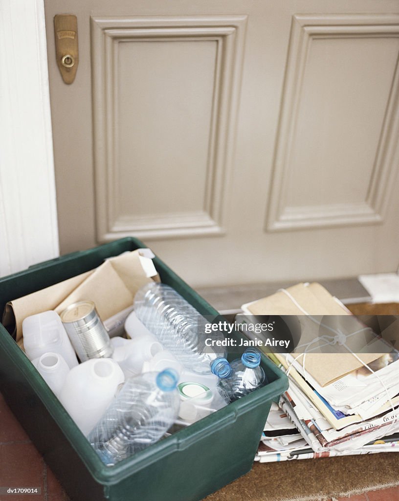 Elevated View of a Carte Filled With Plastic Bottles and a Tied up Bundle of Newspapers