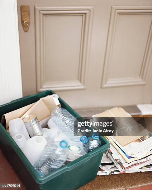 elevated view of a carte filled with plastic bottles and a tied up bundle of newspapers - bordsunderlägg av halm bildbanksfoton och bilder