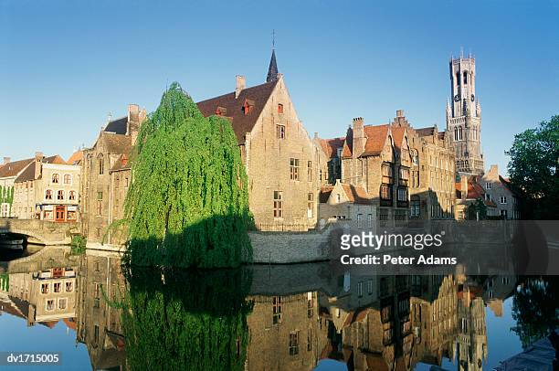 medieval buildings reflected in the river djiver, bruges, belgium - west vlaanderen stockfoto's en -beelden