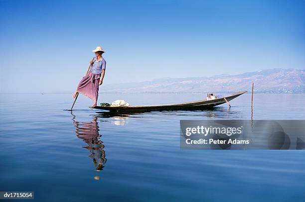 man rowing a fishing boat, inle lake, burma - cultura birmana fotografías e imágenes de stock