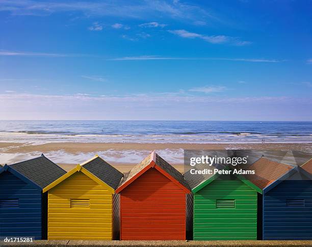 painted beach huts in a line, whitby, england, uk - beach hut stock pictures, royalty-free photos & images