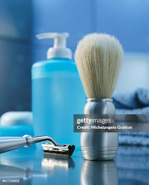 shaving brush, razor and bottle in bathroom - pennello da barba foto e immagini stock