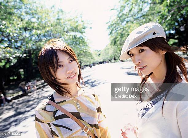 two smiling women in ueno park, tokyo, japan - taito ward stock pictures, royalty-free photos & images