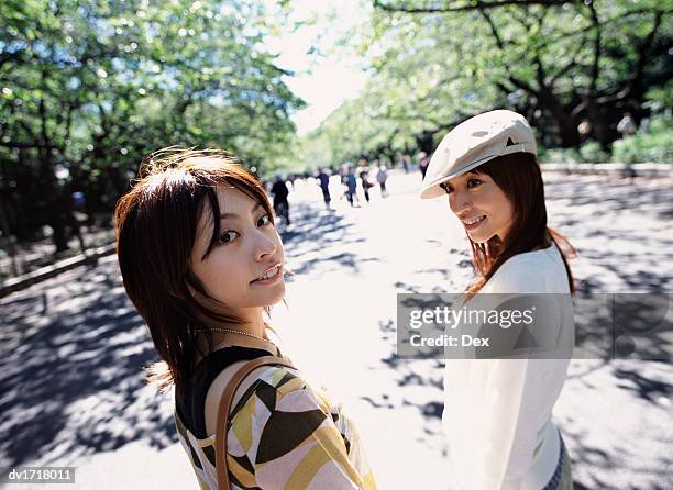 two smiling women in ueno park, tokyo, japan - taito ward stock pictures, royalty-free photos & images