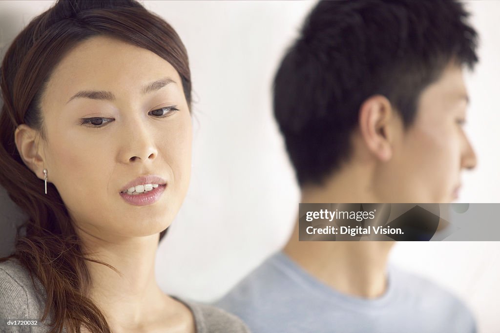 Close-Up of a Couple Sadly Looking Away From Each Other, Focus on Foreground