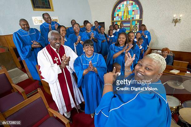 gospel singer leading a choir in a church service - african childrens choir stockfoto's en -beelden