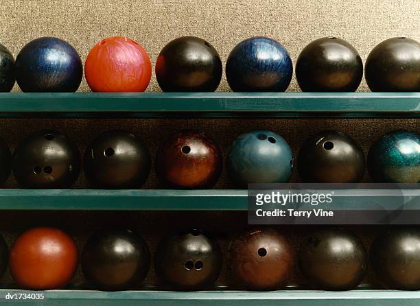 still life of bowling balls on a shelf - bowling alley stock pictures, royalty-free photos & images