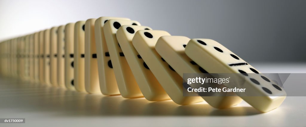 Row Of Dominoes Falling Down High-Res Stock Photo - Getty Images