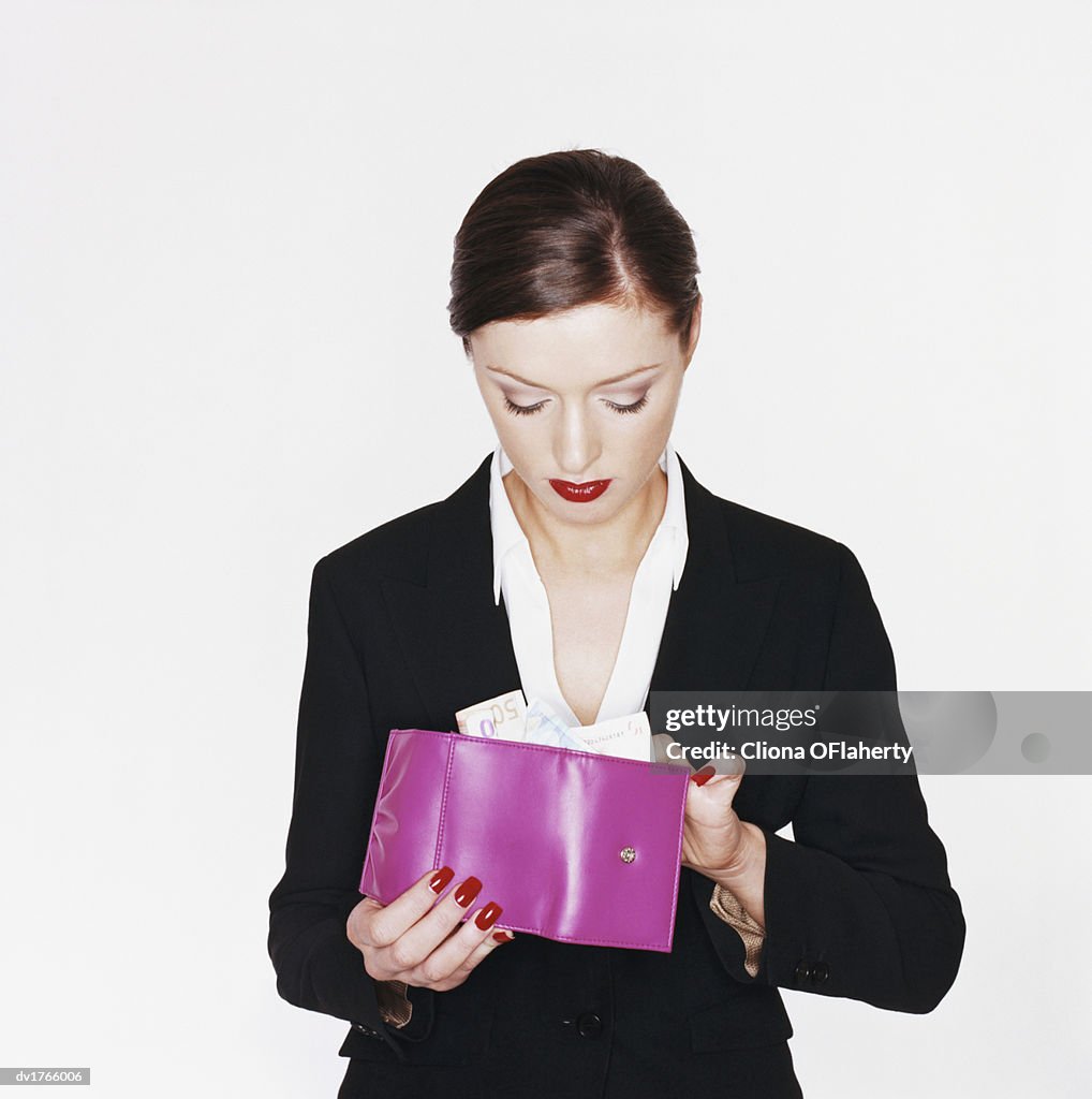 Businesswoman Holding a Pink Wallet With Money