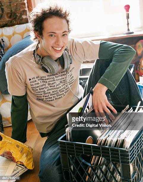 cool bachelor sitting with a crate full of records - bachelor stockfoto's en -beelden