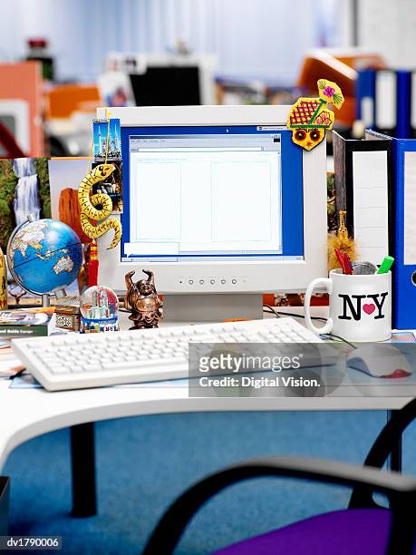 desk covered in international souvenirs and knick knacks - knick stock pictures, royalty-free photos & images