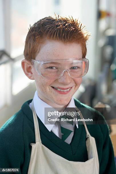 portrait of a schoolboy wearing an apron and protective goggles - boy freckle stock pictures, royalty-free photos & images