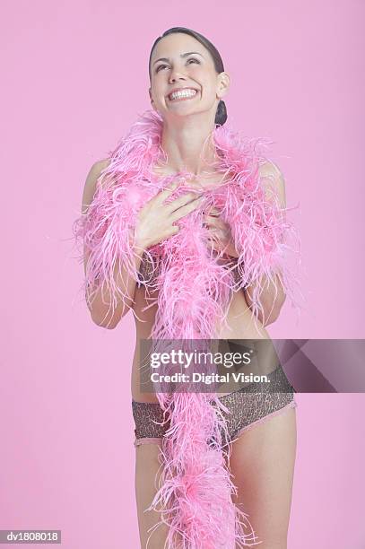 smiling woman wearing underwear holding a pink feather boa - feather boa 個照片及圖片檔