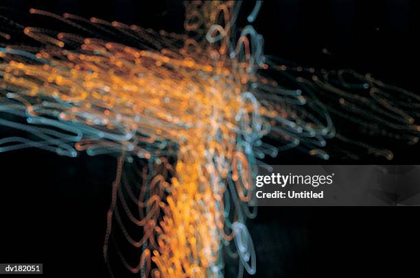 a right angle comprised of orange tracers - right angle stock pictures, royalty-free photos & images