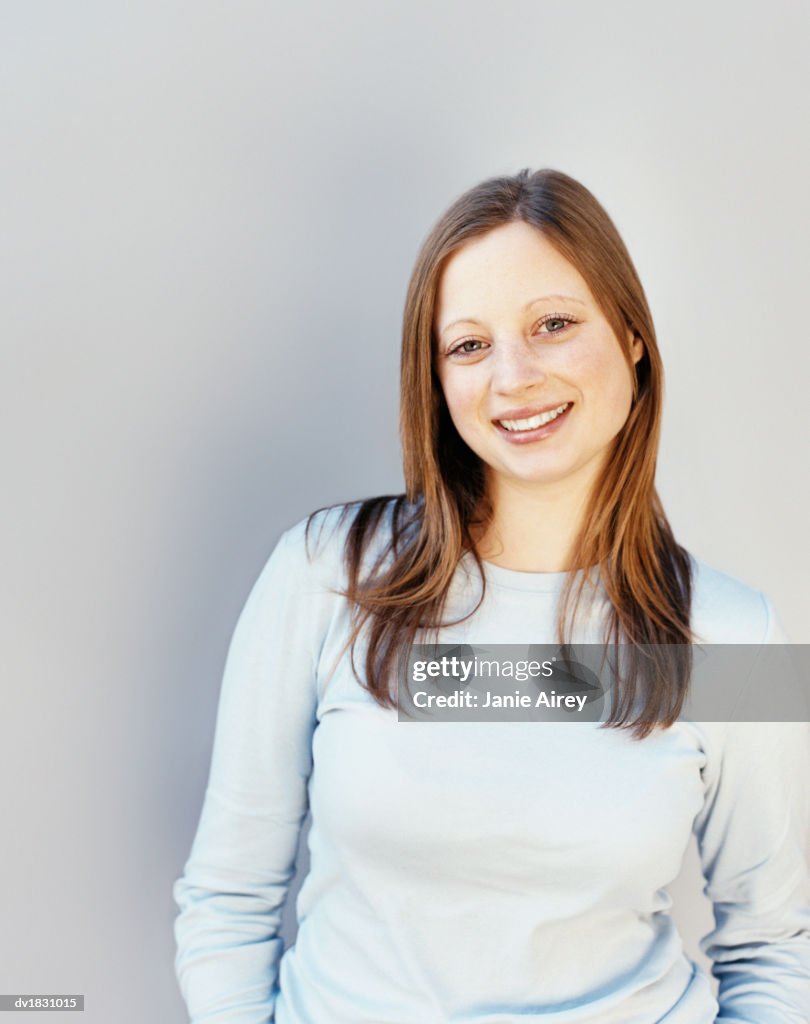 Studio Portrait of a Smiling Teenage Girl