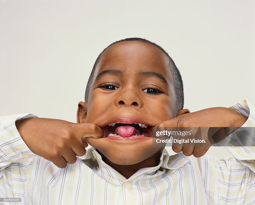 Portrait Of A Young Boy Pulling A Funny Face With His Mouth High-Res Stock  Photo - Getty Images