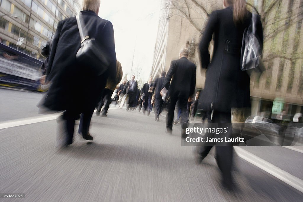 Blurred Motion Shot of a Pedestrians Walking Across a Pedestrian Crossing