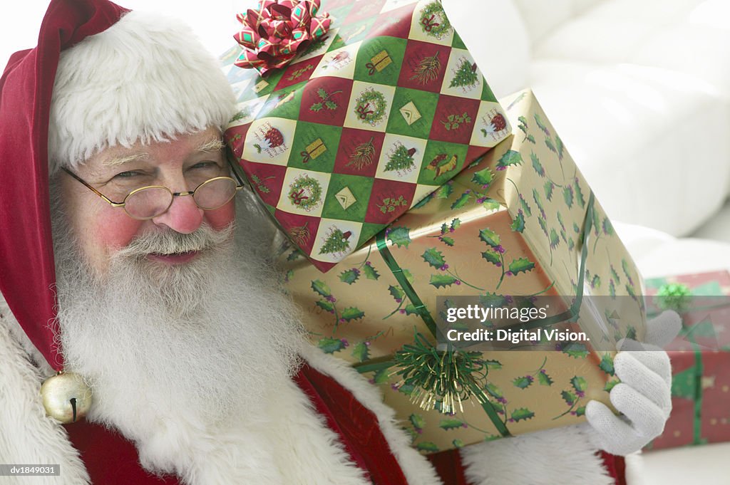 Portrait of Father Christmas Holding Presents