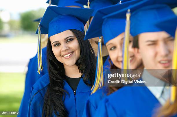 university students standing in line on their graduation day - traje academico imagens e fotografias de stock