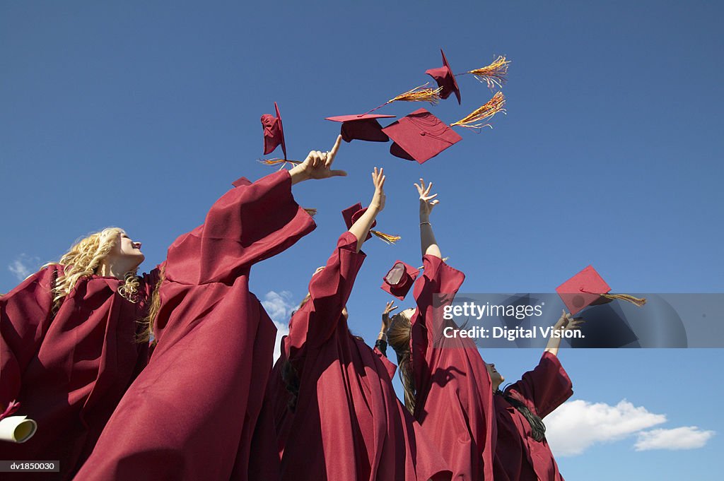 Women Throwing Hats in the Air on Graduation Day