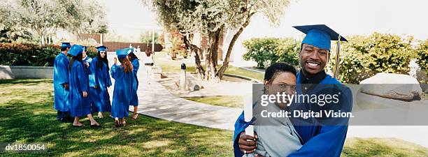 man hugs his mother at his graduation ceremony - son graduation stock pictures, royalty-free photos & images