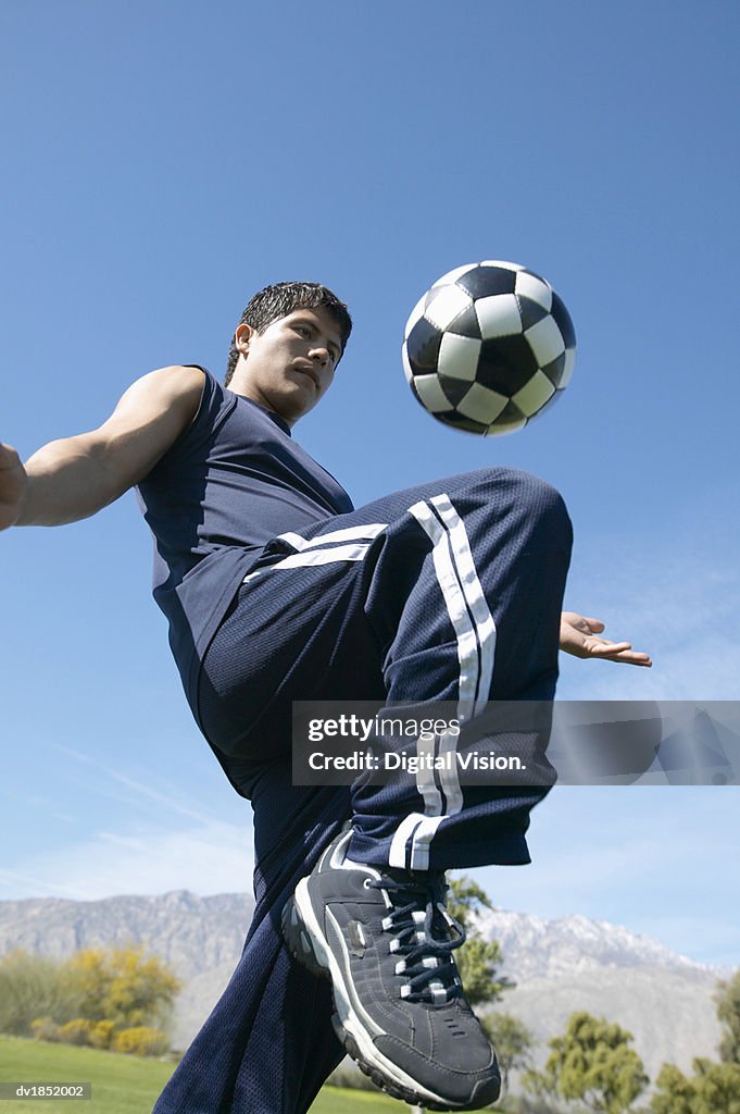 Low Angle View of a Man Playing Keepy Uppy