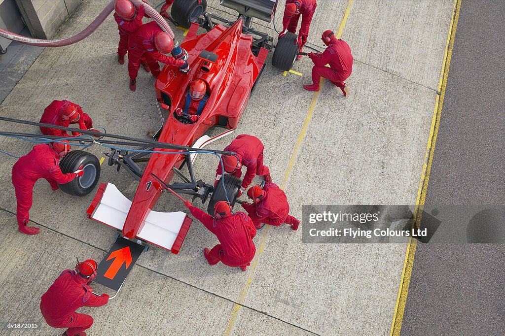 Elevated View of a Pit Stop Mechanics Working on a open-wheel single-seater racing car Racing Car